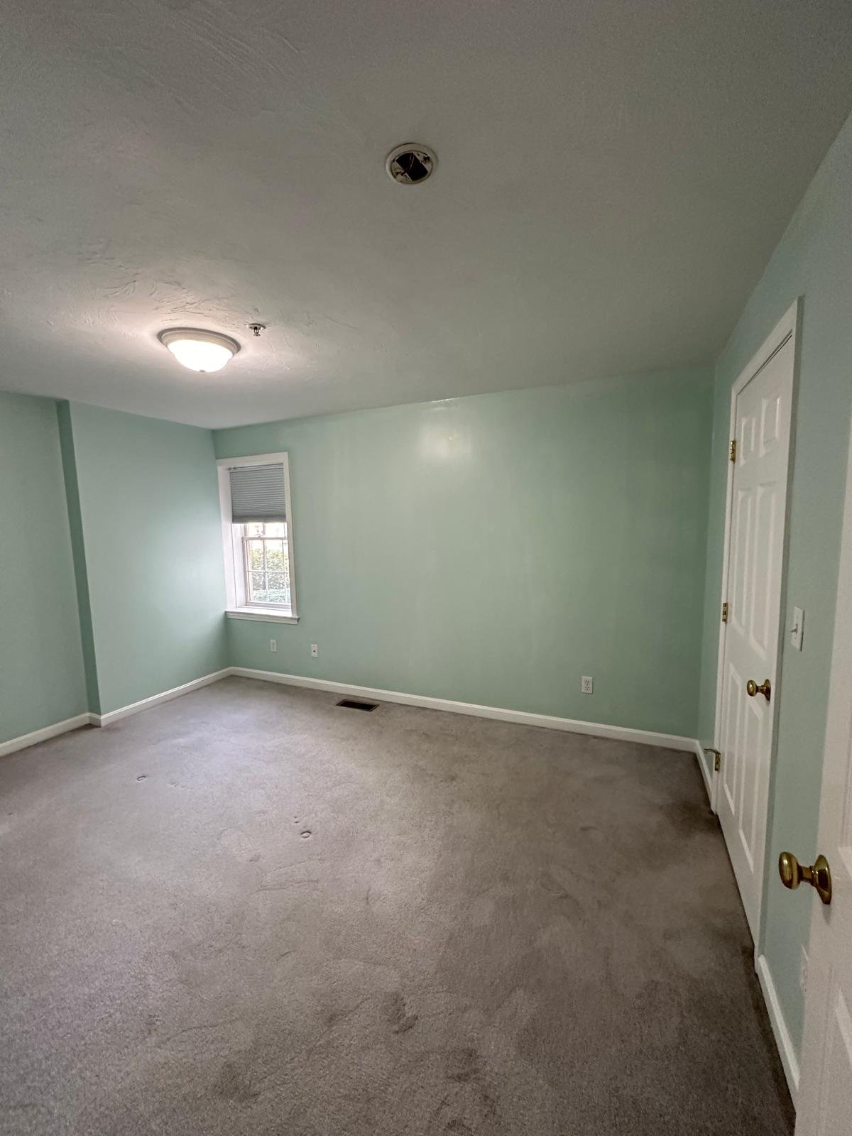 Freshly painted bedroom with white trim in a Concord, MA home