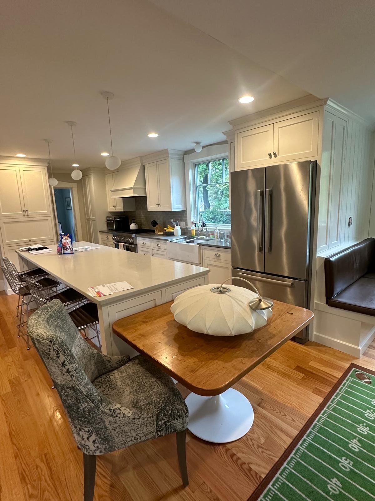 Newton, MA kitchen remodel with a quartz island, custom cabinetry and a farmhouse sink