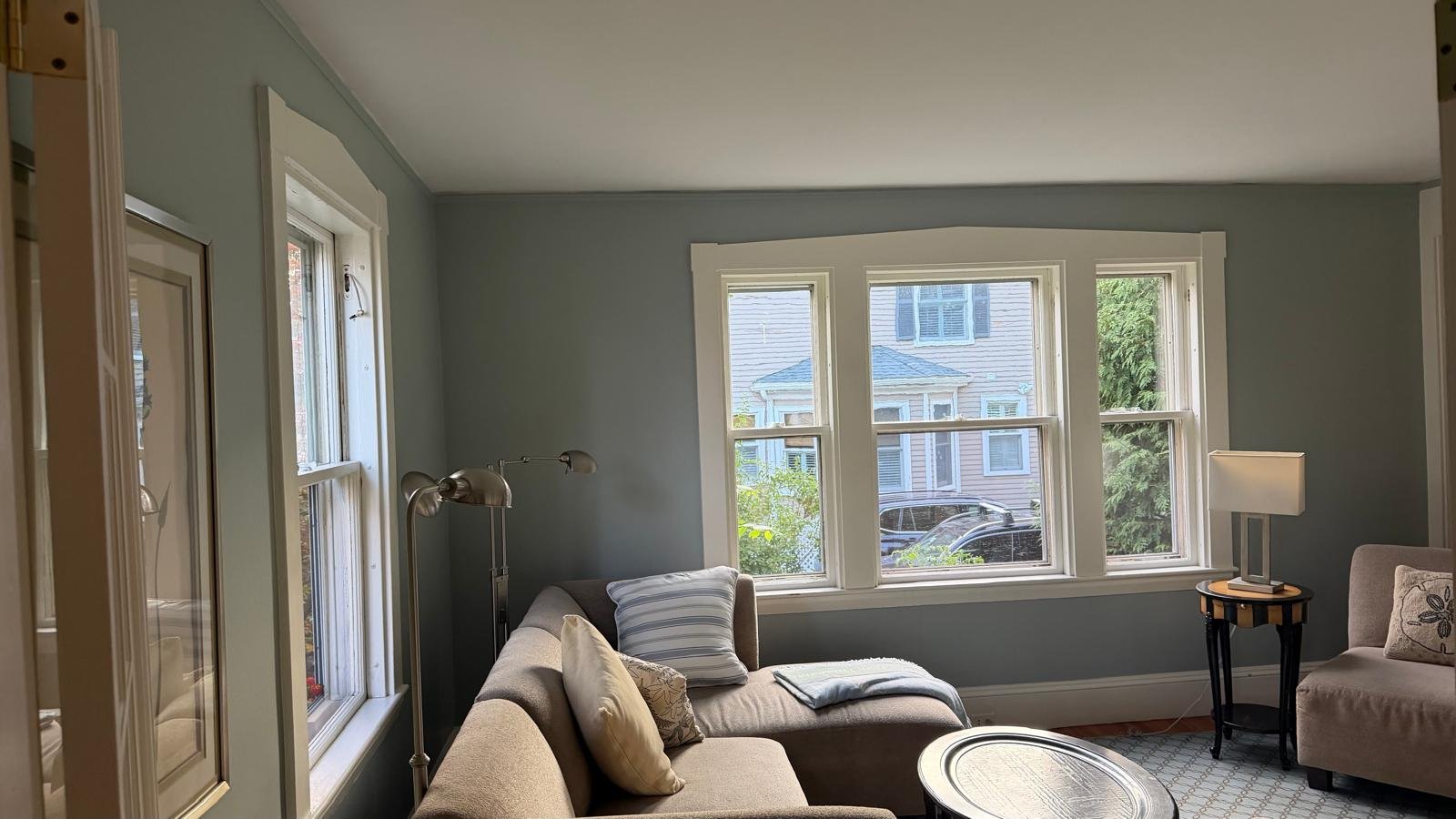 Repainted living room with a bay window in a Newton, MA home
